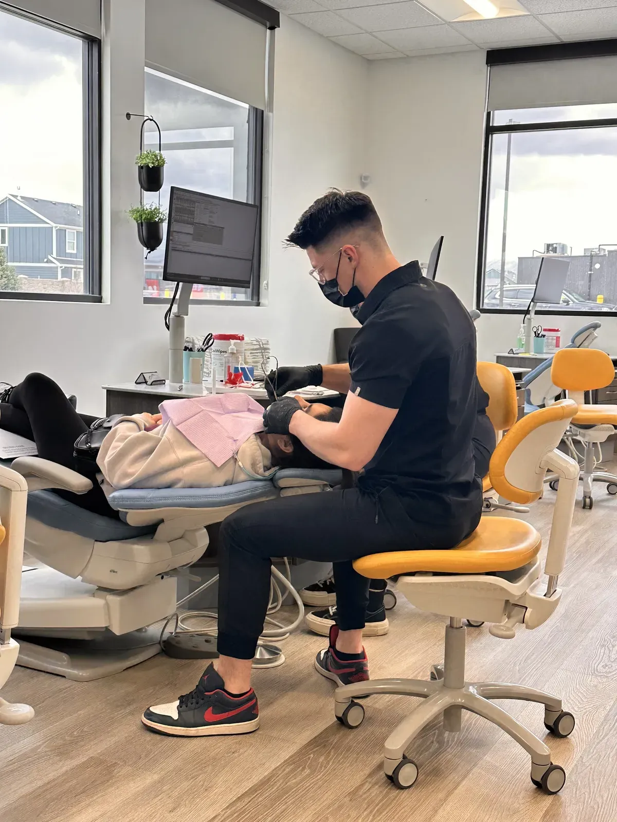 Lake Mountain Dental dentist treating a patient in a bright, modern operatory
